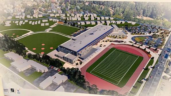 Aerial view of the new school building, turf football field, track and baseball diamonds